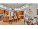 Open kitchen and dining area featuring a breakfast bar with granite countertops and wooden cabinets at 6774 Crescent Woods Cir, Lakeland, FL 33813