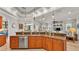 Modern kitchen with stainless steel appliances and breakfast bar, with an open view of the living room at 6774 Crescent Woods Cir, Lakeland, FL 33813