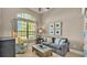 Inviting living room with a large window, comfortable seating, and neutral decor at 6774 Crescent Woods Cir, Lakeland, FL 33813