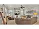 Inviting living room featuring built-in shelving, a large sectional sofa, and a ceiling fan at 6774 Crescent Woods Cir, Lakeland, FL 33813