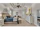 Spacious main bedroom featuring a tray ceiling, fan, large windows, and neutral decor at 6774 Crescent Woods Cir, Lakeland, FL 33813