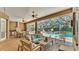 Screened patio with a full outdoor kitchen and dining area overlooking the pool at 6774 Crescent Woods Cir, Lakeland, FL 33813