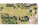 Aerial of expansive property highlighting the green pastures, home and outbuildings, and fence lines at 6981 Snell Rd, Bartow, FL 33830