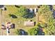 Overhead view features two houses, outbuildings, mature trees, and expansive green space at 6981 Snell Rd, Bartow, FL 33830