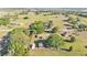 Picturesque aerial view showcasing houses surrounded by ample green space, trees, and a peaceful, rural atmosphere at 6981 Snell Rd, Bartow, FL 33830