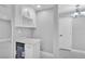 Elegant wet bar features a beverage cooler and wine rack, complemented by modern gray paint and gleaming tile floors at 6981 Snell Rd, Bartow, FL 33830