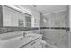 Stylish bathroom featuring a modern vanity, sleek mirror, and a glass-enclosed shower at 6981 Snell Rd, Bartow, FL 33830