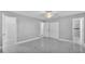 Spacious bedroom with marble-look flooring, multiple doorways, and ample closet space at 6981 Snell Rd, Bartow, FL 33830