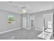 A large bedroom featuring a ceiling fan, sleek tiled floors and access to multiple rooms at 6981 Snell Rd, Bartow, FL 33830
