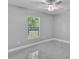 Cozy bedroom featuring a ceiling fan and a window overlooking the serene outdoors at 6981 Snell Rd, Bartow, FL 33830
