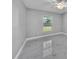Bright bedroom featuring modern gray walls, a ceiling fan, and elegant marble floors at 6981 Snell Rd, Bartow, FL 33830