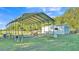 Large metal carport and storage shed provide ample space for outdoor parking and storage at 6981 Snell Rd, Bartow, FL 33830