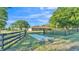 Property view with a home, black fencing, and a driveway leading up to the property entrance at 6981 Snell Rd, Bartow, FL 33830