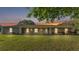 Charming single-story home featuring a large front yard and a welcoming entrance under a colorful twilight sky at 6981 Snell Rd, Bartow, FL 33830