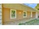 Inviting covered front porch with decorative lighting and large windows at 6981 Snell Rd, Bartow, FL 33830