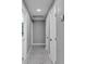 A hallway featuring tiled floors, updated paint, and access to several rooms at 6981 Snell Rd, Bartow, FL 33830