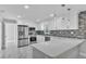 Modern kitchen with white cabinets, stainless steel appliances, quartz countertops, and tile backsplash at 6981 Snell Rd, Bartow, FL 33830