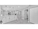 Open concept living space with modern kitchen island featuring white cabinetry and stainless steel appliances at 6981 Snell Rd, Bartow, FL 33830