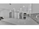 Modern kitchen with white cabinets, stainless steel appliances, and quartz countertops with pendant lights at 6981 Snell Rd, Bartow, FL 33830