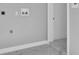 Bright laundry room features sleek tile floor and utility connections for a modern home at 6981 Snell Rd, Bartow, FL 33830
