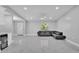 A bright open-concept living room with tile floors and a dark leather sectional sofa at 6981 Snell Rd, Bartow, FL 33830