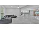 Expansive open-plan living room with modern tile flooring that flows to a bright, well-appointed kitchen at 6981 Snell Rd, Bartow, FL 33830