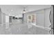 Open floor plan with marble floors, white walls, and a kitchen with stainless steel appliances at 6981 Snell Rd, Bartow, FL 33830