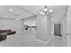 Open-concept living room featuring sleek tile flooring, modern lighting, and seamless flow into the kitchen at 6981 Snell Rd, Bartow, FL 33830
