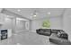 Bright living room with gray walls, marble floors, ceiling fan, and a black leather sectional sofa at 6981 Snell Rd, Bartow, FL 33830