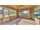 A sunroom enclosed with windows, providing a bright and airy space with views of the surrounding landscape at 6981 Snell Rd, Bartow, FL 33830