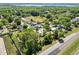 Aerial view showcasing the property's surrounding neighborhood and proximity to a lake at 7324 Thomas Jefferson E Cir, Bartow, FL 33830