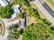 Aerial view of the home showing the roof solar panels and proximity to the road at 7324 Thomas Jefferson E Cir, Bartow, FL 33830