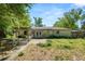 Quaint backyard featuring a patio area and mature trees offering natural shade at 7324 Thomas Jefferson E Cir, Bartow, FL 33830