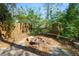 Private backyard area featuring a fire pit, bench, and mature trees at 7324 Thomas Jefferson E Cir, Bartow, FL 33830