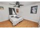 Bedroom with a bed, ceiling fan and laminate flooring at 7324 Thomas Jefferson E Cir, Bartow, FL 33830