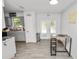 Eat-in kitchen area featuring gray wood-look tile flooring, a table, and backyard access at 7324 Thomas Jefferson E Cir, Bartow, FL 33830