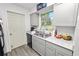 A kitchen with stainless steel sink, gray cabinets, laminate countertops, and wood-look flooring at 7324 Thomas Jefferson E Cir, Bartow, FL 33830