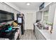 Functional kitchen featuring gray wood-look tile, appliances, and lots of natural light at 7324 Thomas Jefferson E Cir, Bartow, FL 33830