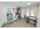 Bright kitchen and dining area featuring gray wood-look tile and modern appliances at 7324 Thomas Jefferson E Cir, Bartow, FL 33830