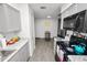 A kitchen features grey cabinets, countertops, black appliances and wood-look flooring at 7324 Thomas Jefferson E Cir, Bartow, FL 33830