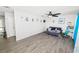 Spacious living room with gray wood-look tile flooring, a ceiling fan, and lots of natural light at 7324 Thomas Jefferson E Cir, Bartow, FL 33830