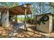 Backyard bar and grill area with a covered patio, brick accents, and a shed with a gecko at 7324 Thomas Jefferson E Cir, Bartow, FL 33830