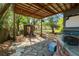 Backyard bar area with a covered patio and stone flooring; next to a small shed at 7324 Thomas Jefferson E Cir, Bartow, FL 33830