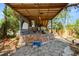 Backyard bar area with a covered patio and stone flooring; in need of repair at 7324 Thomas Jefferson E Cir, Bartow, FL 33830