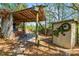 Backyard bar and grill area with a covered patio, brick accents, and a shed with a gecko at 7324 Thomas Jefferson E Cir, Bartow, FL 33830