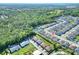 Scenic aerial shot showcases a community nestled among wooded areas, featuring tidy homes and a tranquil pond at 7445 Ibis Dr, Lakeland, FL 33810