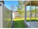 View of the backyard, fenced for privacy, with a covered patio and grassy area, perfect for outdoor enjoyment at 7445 Ibis Dr, Lakeland, FL 33810
