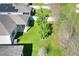 Aerial view of the backyard featuring a covered patio, well-maintained lawn, and mature trees at 7445 Ibis Dr, Lakeland, FL 33810