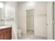 Bright bathroom featuring a toilet and a vanity with a light granite countertop and brown cabinetry at 7445 Ibis Dr, Lakeland, FL 33810
