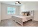 A cozy bedroom features a ceiling fan, light gray floor, and a window allowing natural light at 7445 Ibis Dr, Lakeland, FL 33810